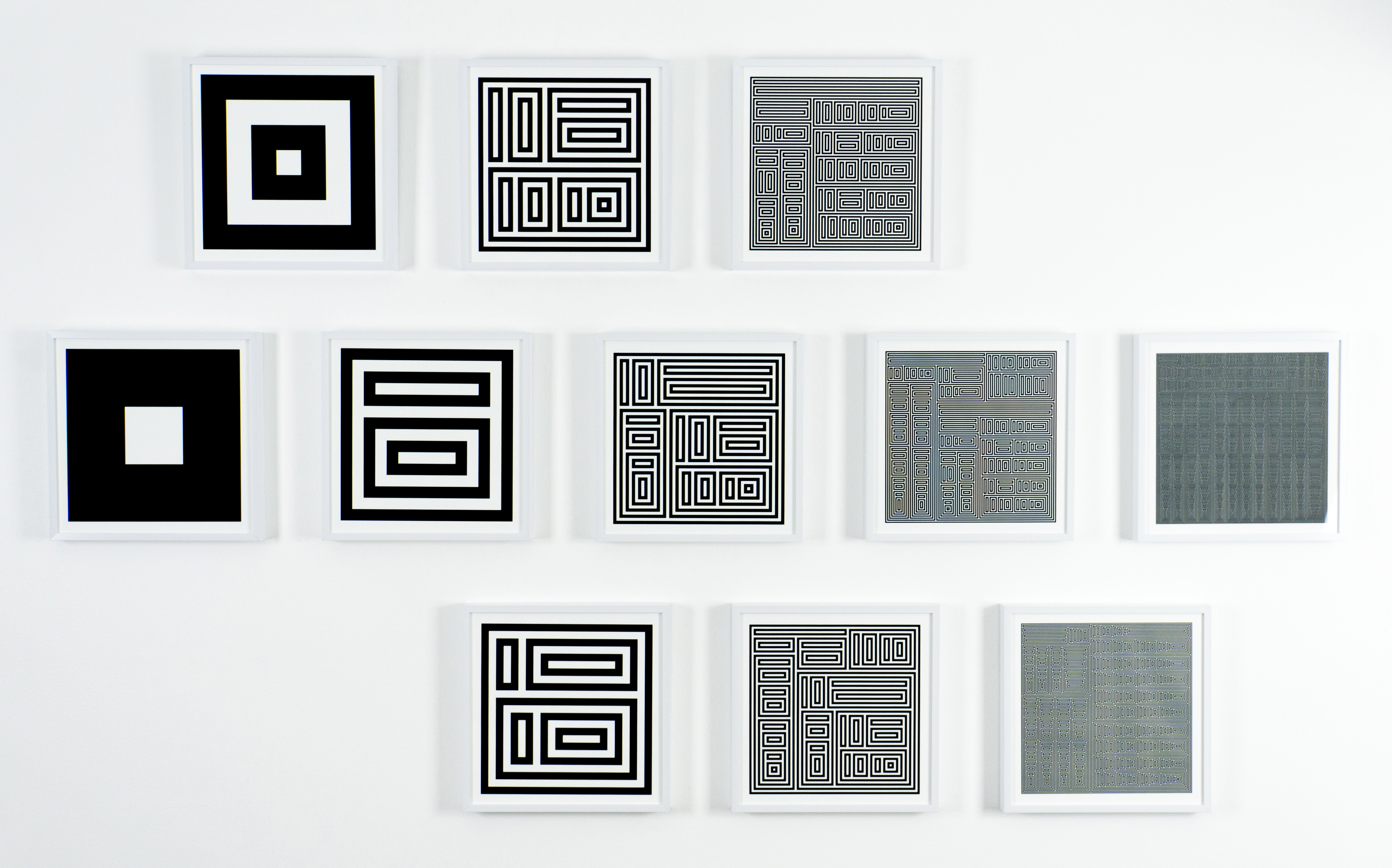 photograph of eleven metal prints of the Von Neumann Ordinals Series by Jennifer E. Padilla